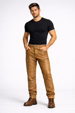 Mens tan leather jogger pants by Rustic Leathers front view male model grey background
