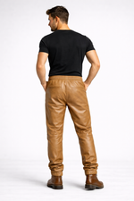 Mens tan leather jogger pants by Rustic Leathers back view male model grey background