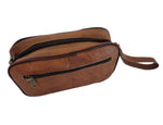 Brown leather bag with a strap on a white background