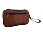 Brown leather clutch bag with a strap on a white background