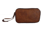 Brown leather clutch bag on a white background
