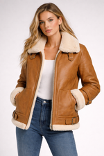Woman wearing a brown leather jacket with white fur trim on a white background