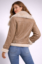 Woman wearing a tan leather jacket with white fur trim on a white background